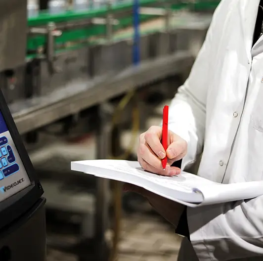 Technician monitoring RC Cola production system