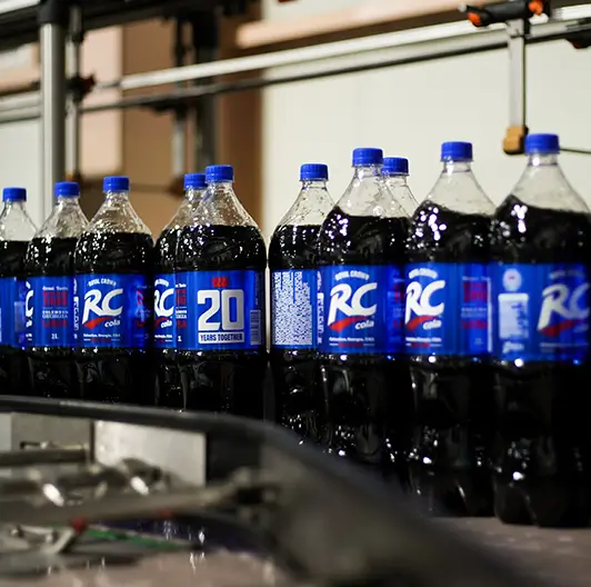RC Cola bottles aligned on conveyor line