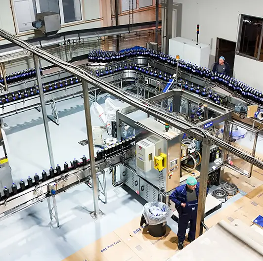 Overhead view of automated bottling machinery at Royal Beverage